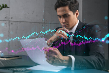 Man in office think and dream datum financial service forex graph and chart technology drawing...