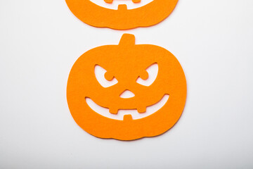 Frame of halloween decoration on pastel white background. Flat lay orange pumpkins. Top view with copy space. Holiday greeting card mockup.