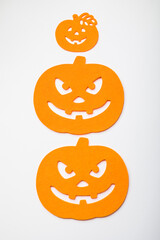 Frame of halloween decoration on pastel white background. Flat lay orange pumpkins. Top view with copy space. Holiday greeting card mockup.