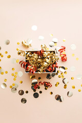 Open festive box with tinsel and confetti. Celebrating Christmas or New Years or winning a prize or...