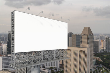 Obraz premium Blank white road billboard with Singapore cityscape background at sunset. Street advertising poster, mock up, 3D rendering. Side view. The concept of marketing communication to sell idea.