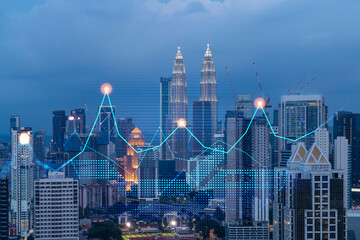 Obraz na płótnie Canvas Stock market graph hologram, night panorama city view of Kuala Lumpur. KL is popular location to gain financial education in Malaysia, Asia. The concept of international research. Double exposure.