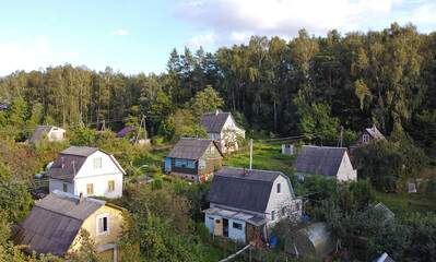 Top view of suburban villas near the park. Landscape with roofs of small houses
