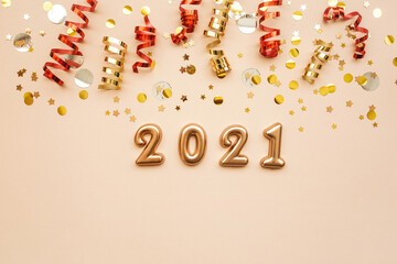 Gold numbers 2021 on a pink background with holiday decorations. New Year and Christmas background.