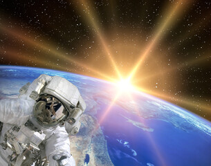 Fototapeta na wymiar Astronaut and sunrise. The elements of this image furnished by NASA.