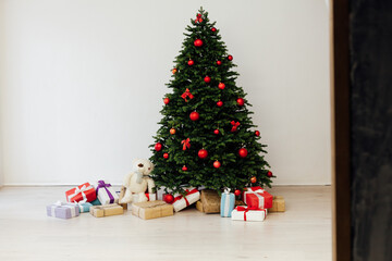 Christmas tree pine with red decor with gifts interior postcard for the new year