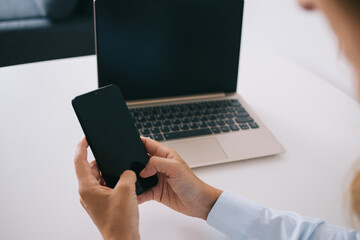 Unrecognizable woman messaging on smartphone