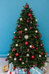 Fototapeta na wymiar Christmas tree pine with gifts new year decor interior of the holiday postcard