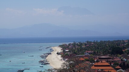 Fototapeta premium Balinese volcano above the clouds seen from a viewpoint of a neighboring island