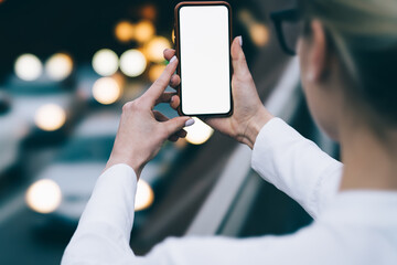 Unrecognizable woman taking picture on smartphone