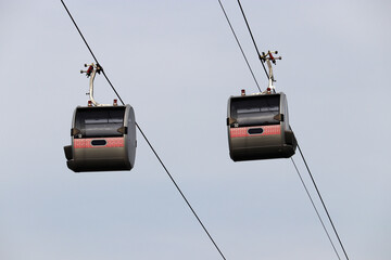 Cable car cabins on sky background. Ropeway gondola close up