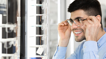 Portrait of smiling young guy wearing spectacles