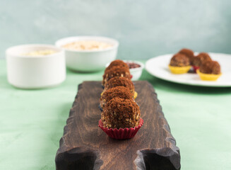 Protein energy balls with cocoa, dried fruit, nut butter and seeds. Healthy dessert, snack.