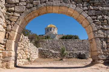 Fototapeta na wymiar old Orthodox Church and old stone arch