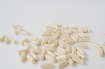 Fototapeta na wymiar many pharmacy capsules drugs vitamin lying on white surface background with copy space