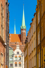 Pointed towers of St. Mary’s Basilica - Bazylika Mariacka - in back of Kramarska street in the historic old town city center quarter of Gdansk, Poland