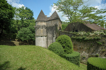 In the Périgord, this old farmhouse is surrounded by ramparts with a corner tower.