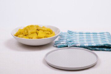 Stewed potato with spices in bowl on the tablecloth.