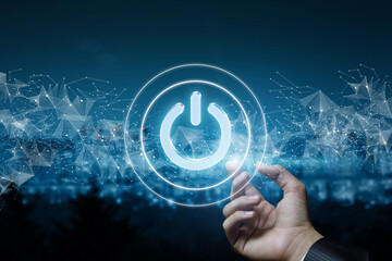 Hand shows Power icon on blurred background.