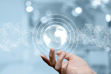 Hand shows the Globe on a network background.
