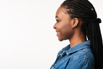 Obraz premium African Lady With Braided Hairstyle Posing Over White Background, Side-View
