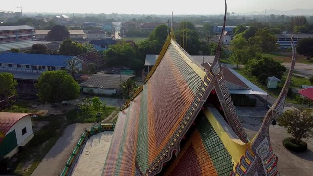 Orbit of ornate mosaic decorations at top of Thai Buddhist temple
