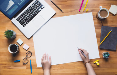 Top view of young person working on table with white space background.Business plan
