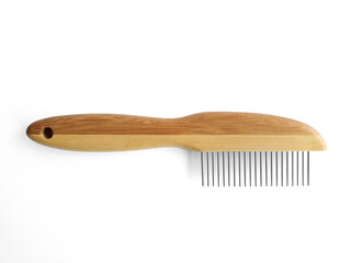 Wooden pet bristle brush isolated on white background. Care of the coat of dogs, cats with a brush of fine metal bristles and joints. Accessories for the grooming of the dog.