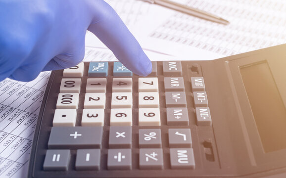 Accountant In Gloves Calculating Money Budget During Coronavirus Pandemic