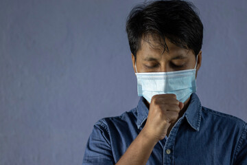 man coughing in mask