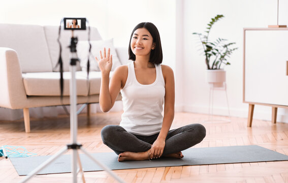 Sporty Asian Woman Waving To Camera, Home Training Concept