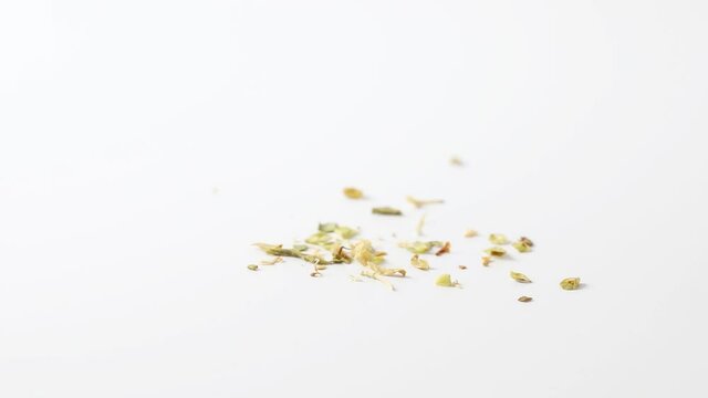 Making a heap of dried zaatar leaves close up