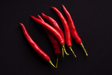 Fresh red chilies on a black background