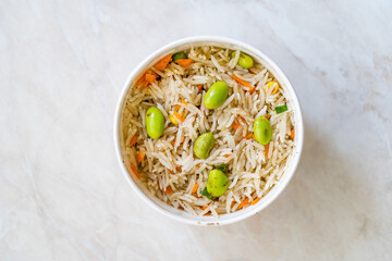 Take Away Boiled Steamed Basmati Rice with Edamame Beans in Plastic Cup Box Container.