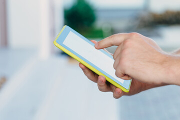 shot of male hands holding modern tablet pc mock-up outdoors
