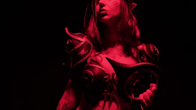 A costume on a girl for Halloween in the form of a warlike elf on a black background with smoke.