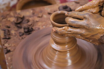 Dirty Hands Of Potter Making Pottery From Mud Using Spinning Potter Wheel