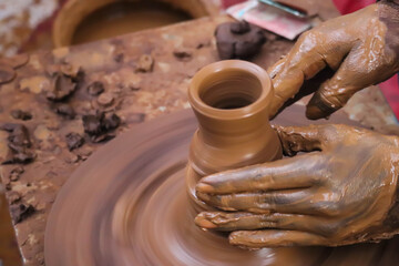 Dirty Hands Of Potter Making Pottery From Mud Using Spinning Potter Wheel