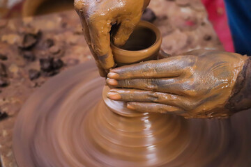 Hands And Fingers Posture Of Potter Making Pottery From Mud Using Spinning Potter Wheel