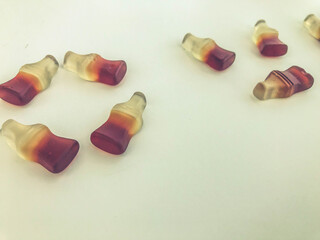 letters are laid out on a yellow matte marmalade background. gelatin candy in the form of bottles with lemonade. Valentine's Day. creative sweet and edible lettering