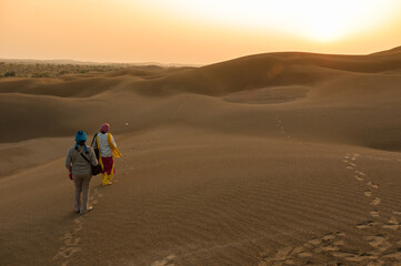 person walking on the dunes in Jaisalmer, Rajasthan, India
