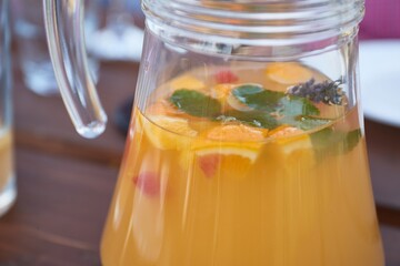 Serving fresh lemonade in a jug in a restaurant