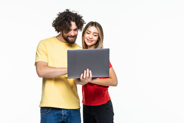 Attractive young couple holding their laptop isolated on white background