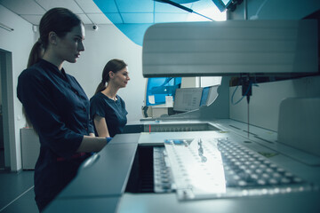 Confident lab scientists using their modern equipment