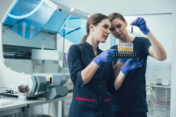Curious medical workers consulting each other about samples