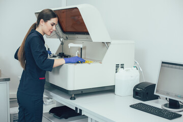 Smiling lab technician putting new samples for detailed analysis