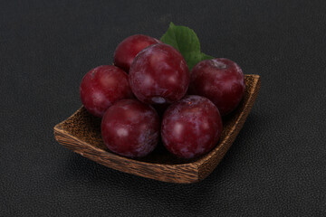 Plum heap in the wooden basket