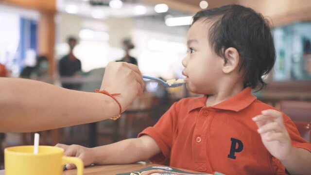 Mother weaning her son but the boy refuse to eat more 
