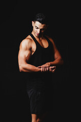 Fototapeta na wymiar muscular man on a black background