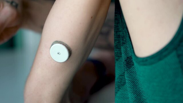 Person taking Reading Device with hand To The Sensor For Measuring Glucose.Close up.